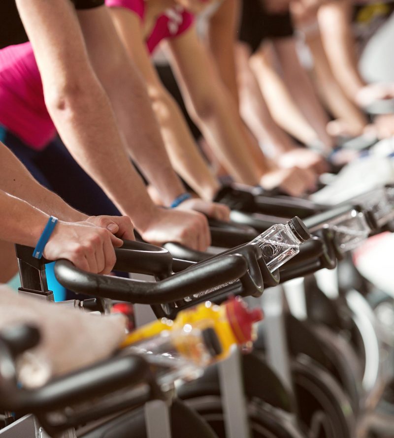 gym detail shot - people cycling; spinning class